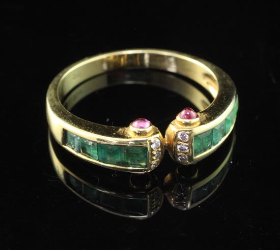 A stylish 18ct gold, emerald and diamond ring, size O.